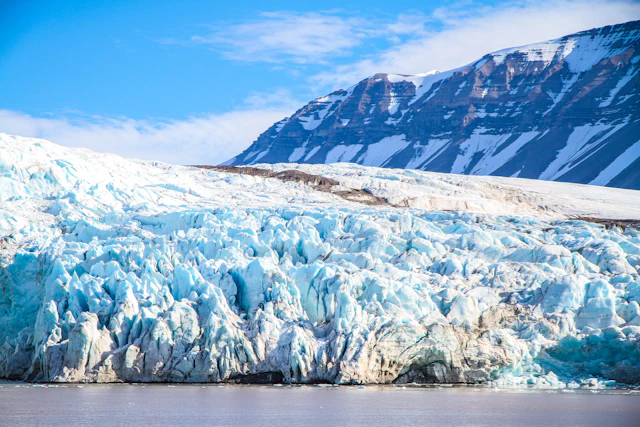 Snow-covered glacier meeting the Arctic sea in Svalbard