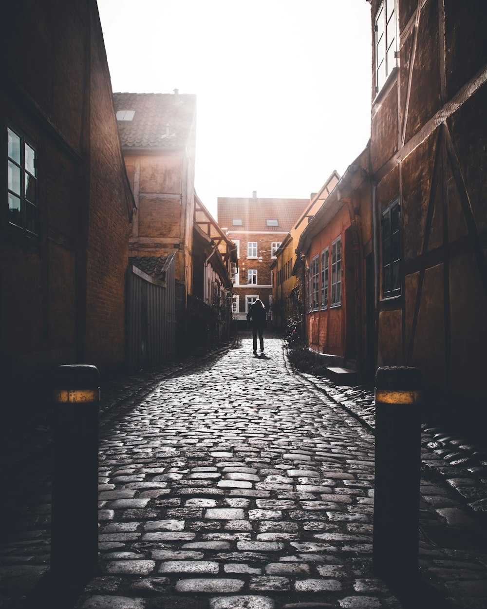 person standing between houses