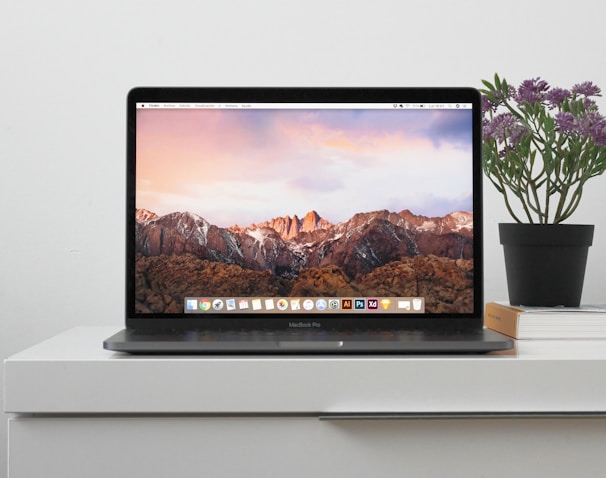 MacBook on top white table