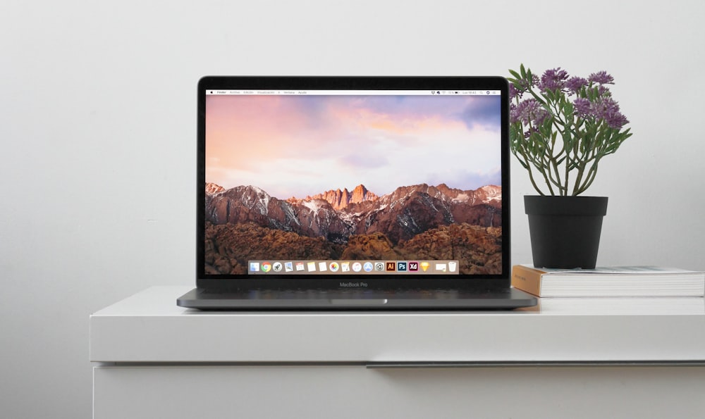 MacBook on top white table