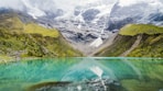 body of water with green mountains during daytime