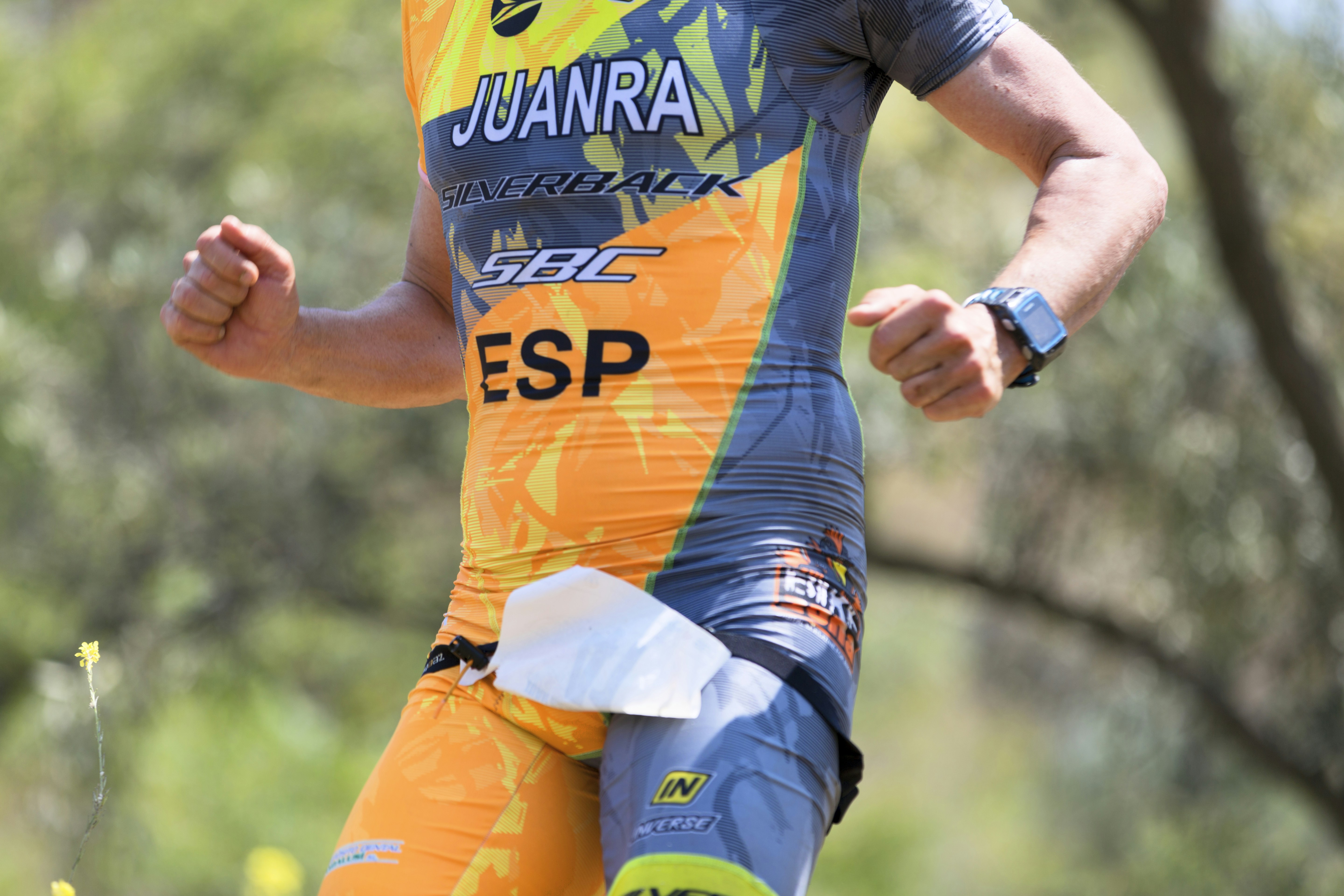 Athletic model running in technical sportswear, motion blur, outdoor track