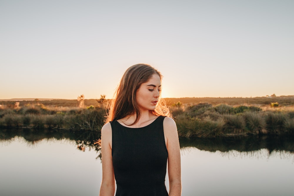 woman standing near pond