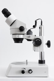 white and black microscope on white surface