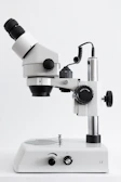 white and black microscope on white surface