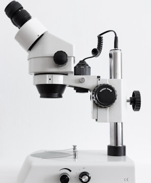 white and black microscope on white surface