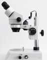 white and black microscope on white surface