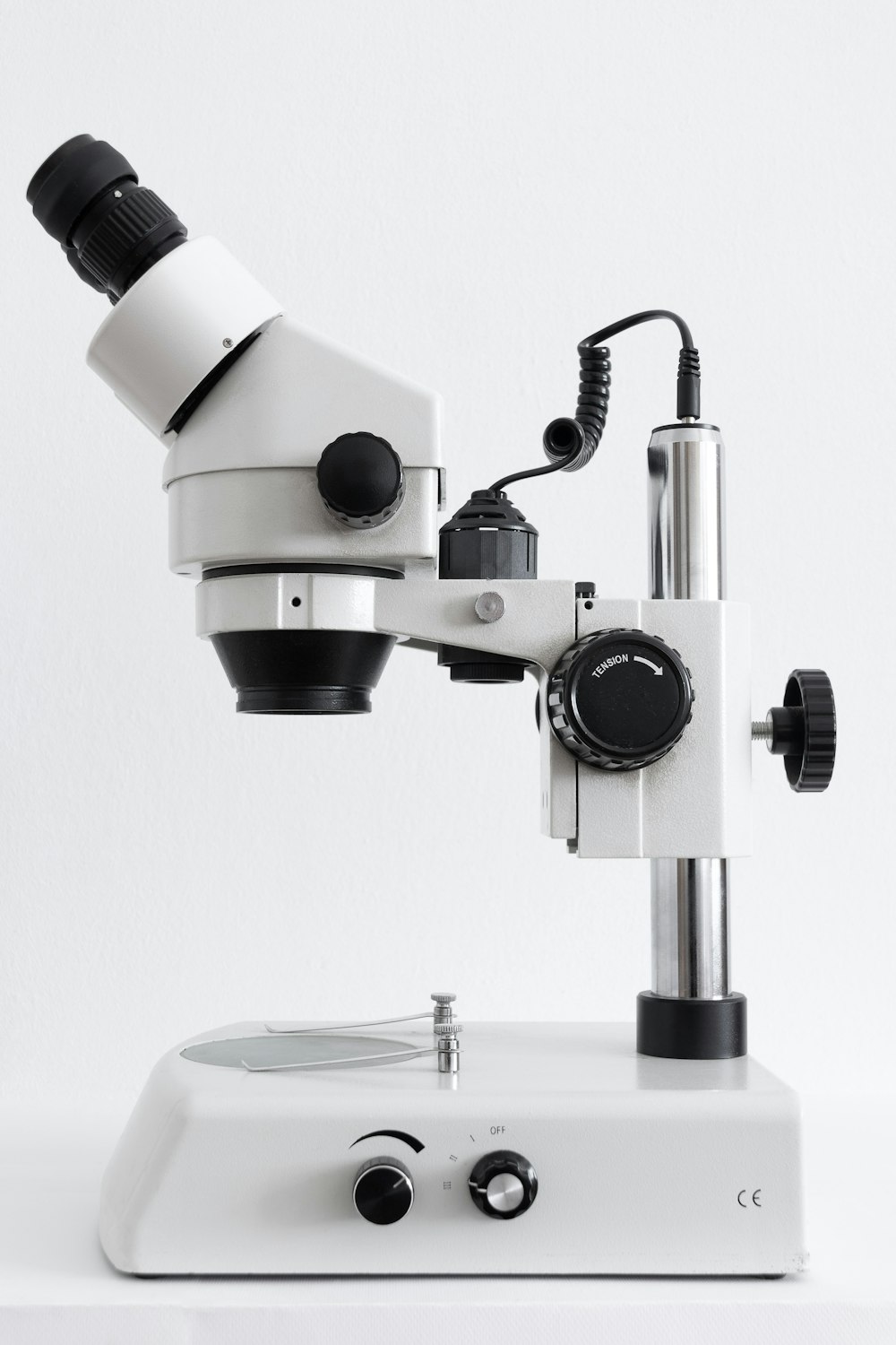 white and black microscope on white surface