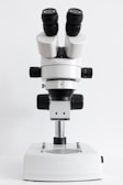 A modern laboratory microscope with clear glass lenses and adjustable knobs.