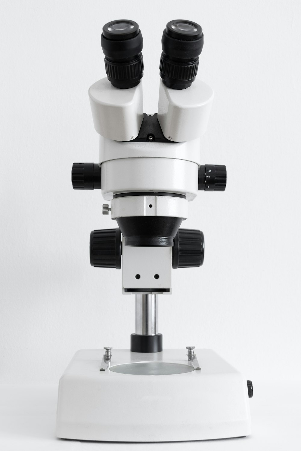 Microscópio branco e preto na superfície branca