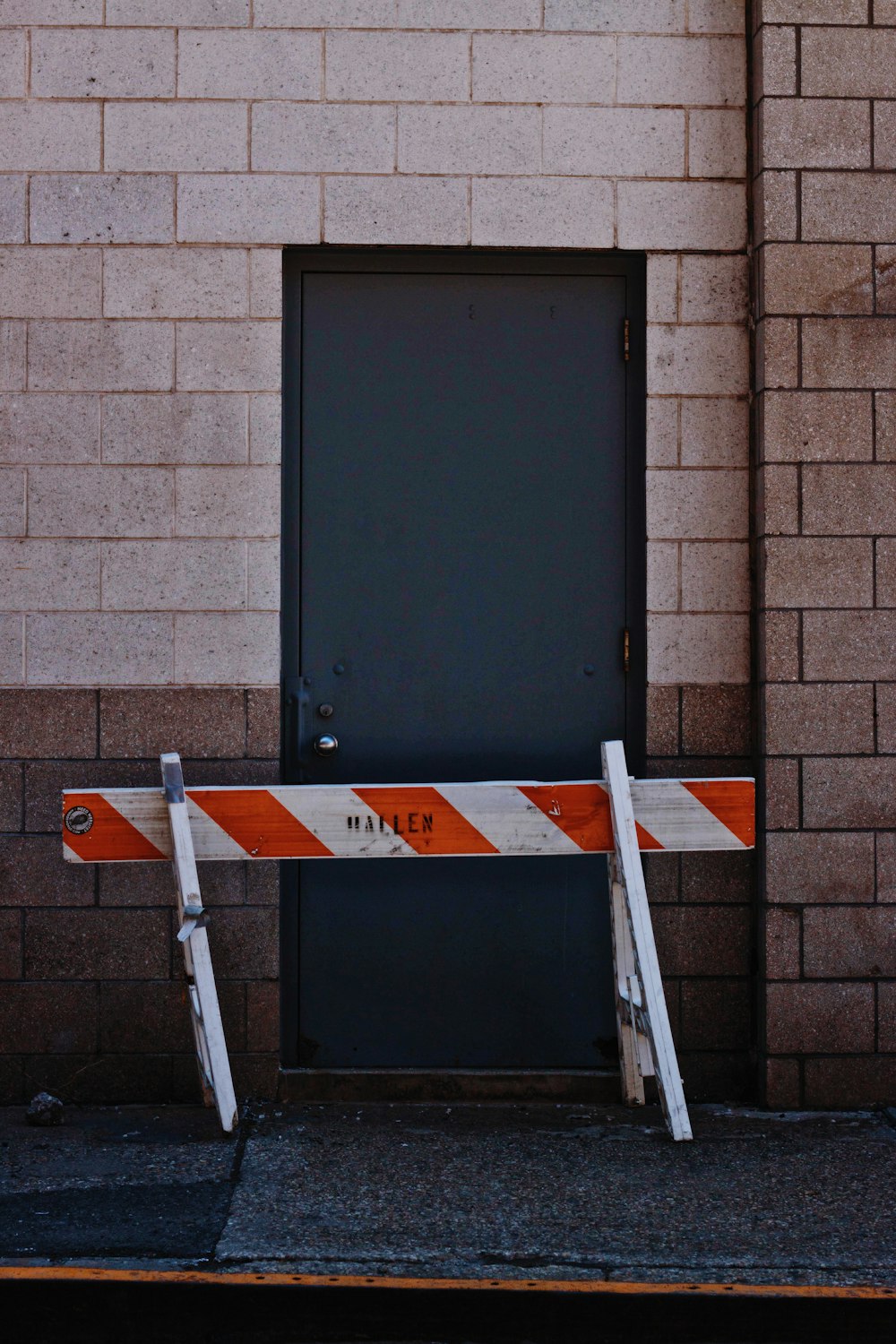 white and orange wooden fence beside black door