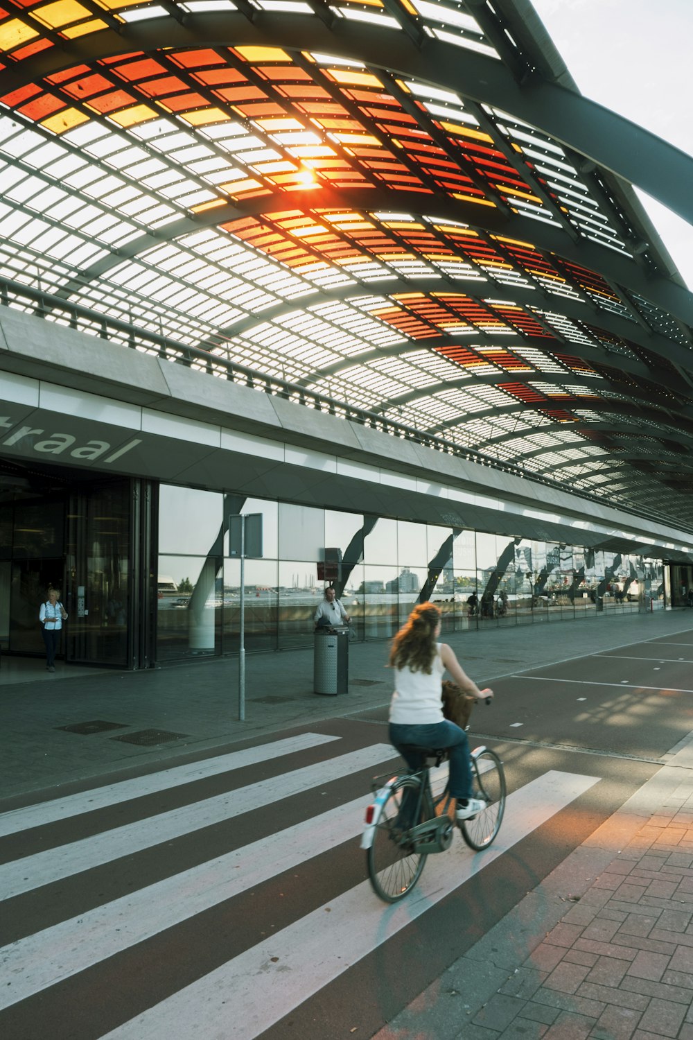 woman riding beach cruiser bicycle on pedestrian lane