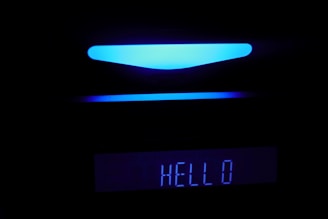 A futuristic AI voice assistant interface glowing in cobalt blue on a sleek black background.