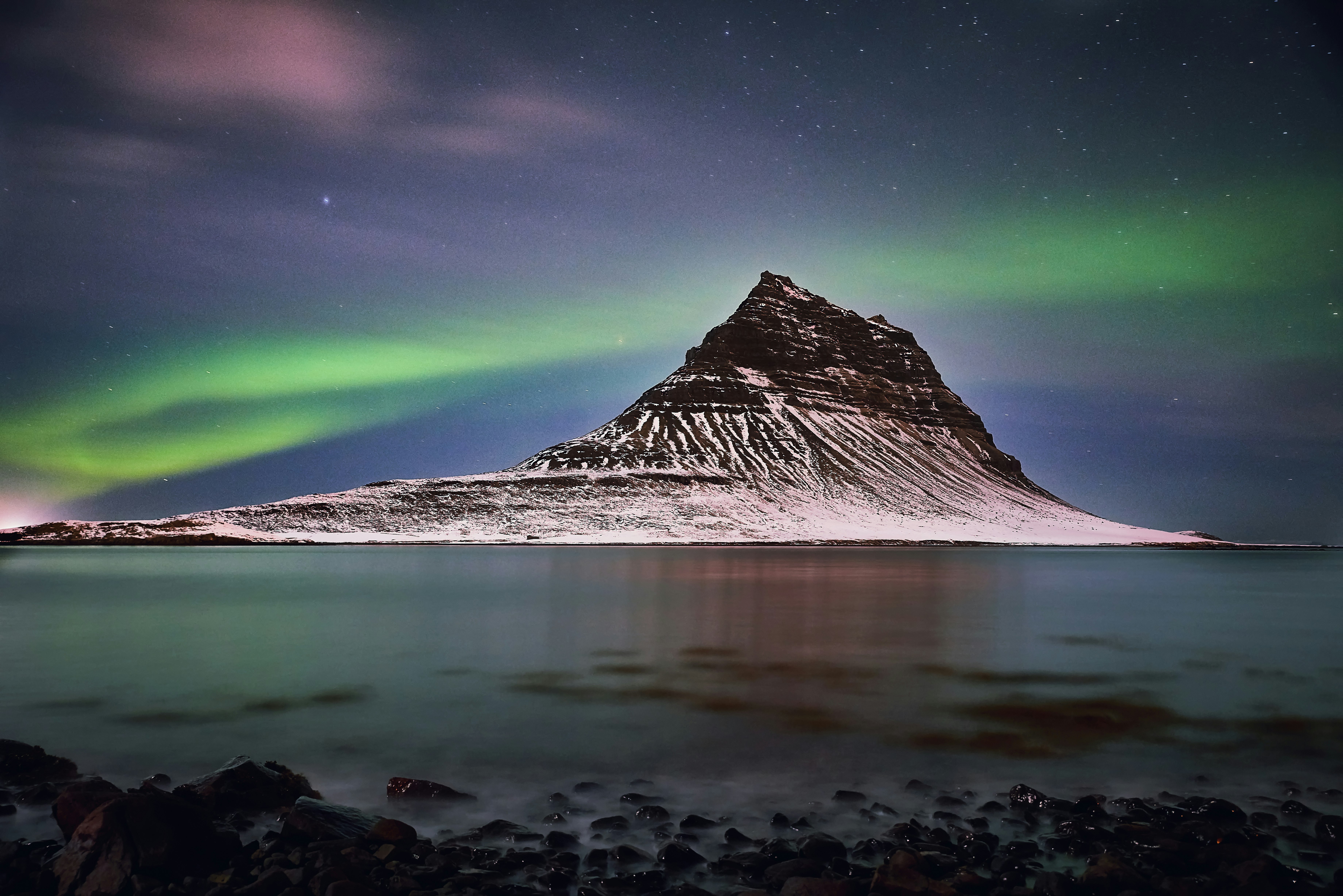 snow capped mountain under aurora