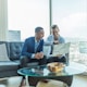 MLM two men in suit sitting on sofa