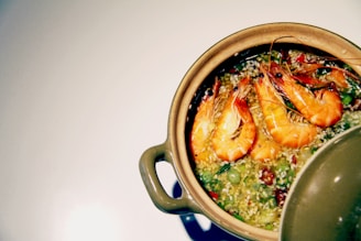 Close-up of a vibrant meal featuring prawns, broccoli, and mixed vegetables in a stylish container.