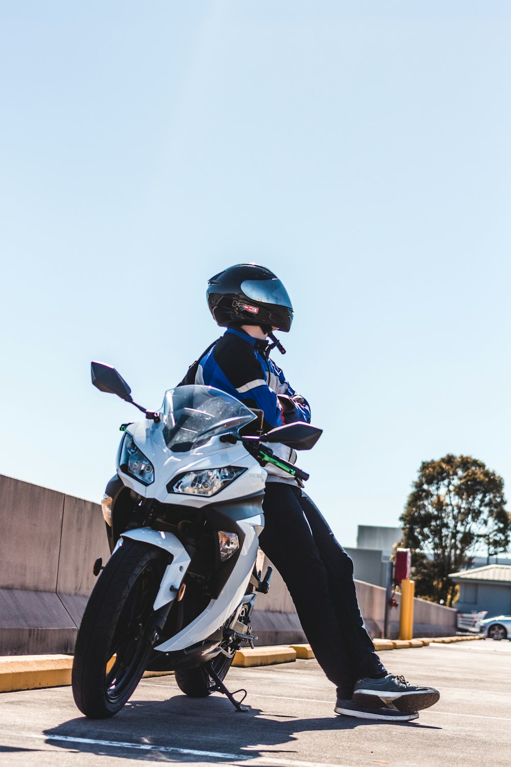 man sitting on sports bike