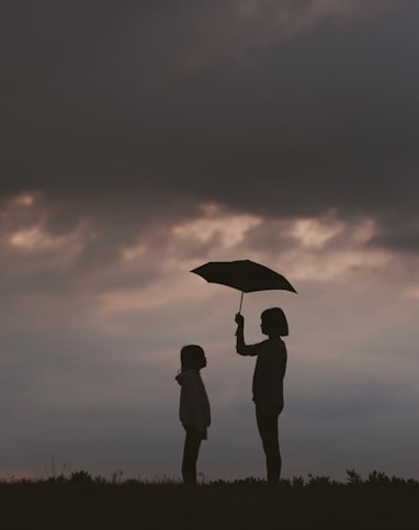 girl holding umbrella on grass field