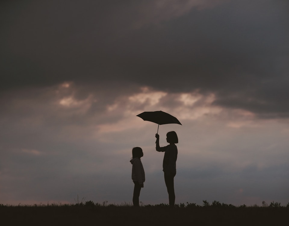 girl holding umbrella on grass field