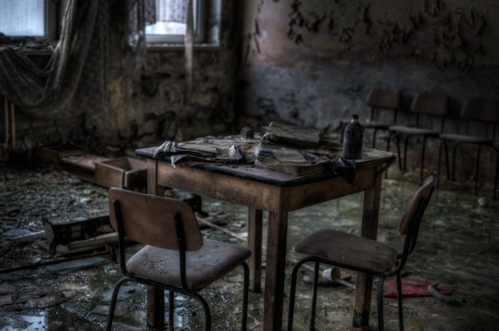 brown wooden table beside chairs