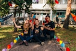 four people sitting near road