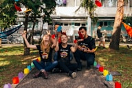 four people sitting near road
