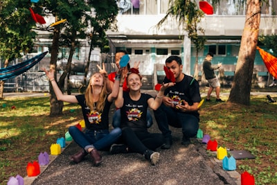 four people sitting near road