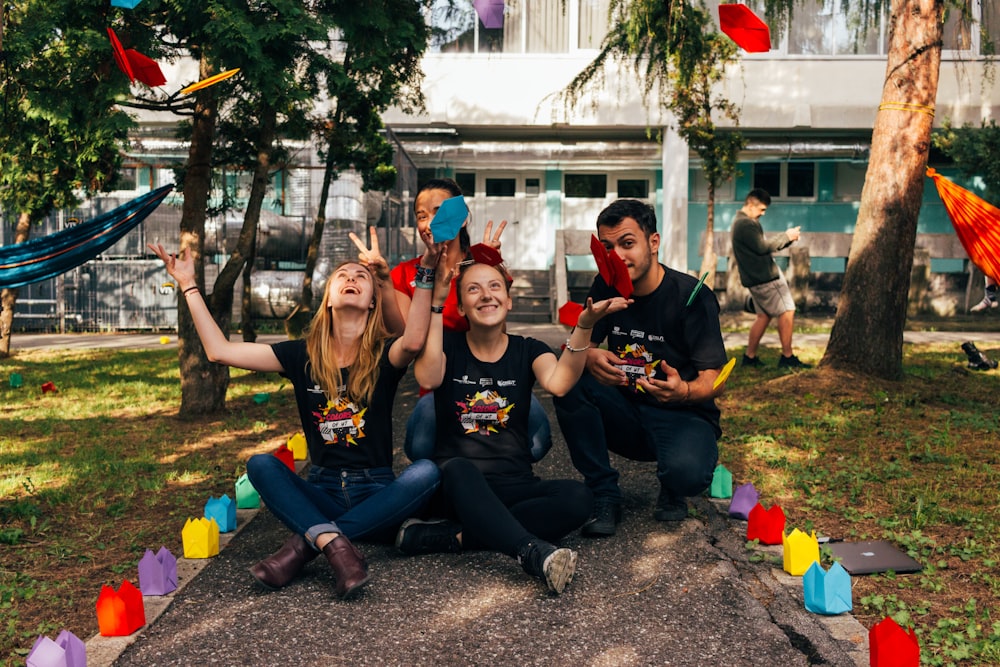 four people sitting near road