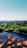 A serene view of the sky gardens at sunset, highlighting the lush greenery and modern architecture.
