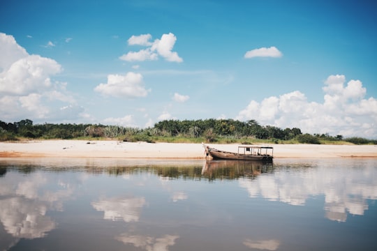 brown boat at body of water near shore in Pekanbaru Indonesia