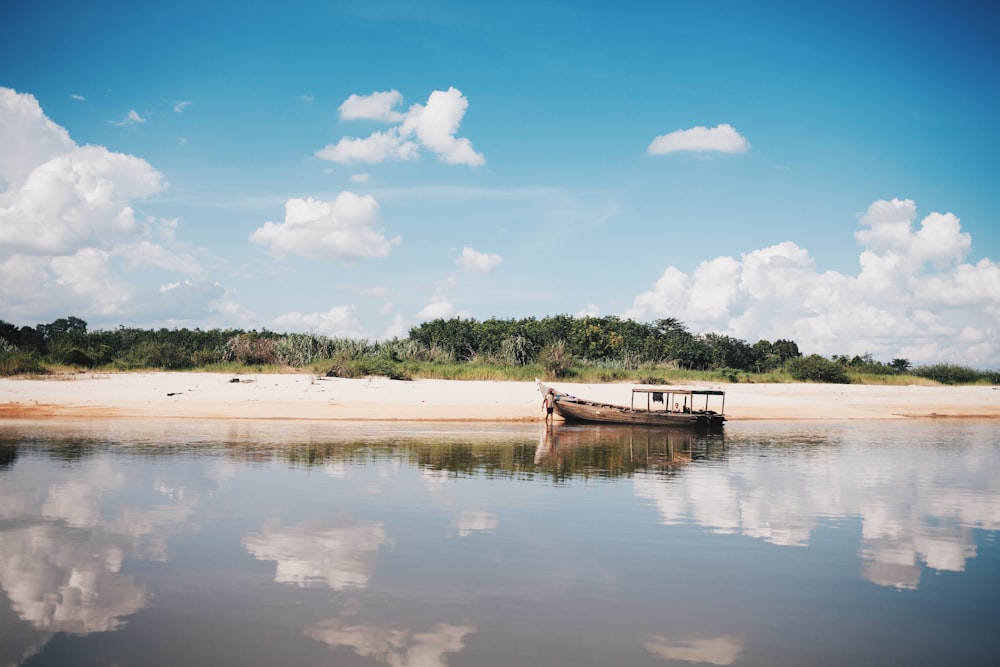 brown boat at body of water near shore