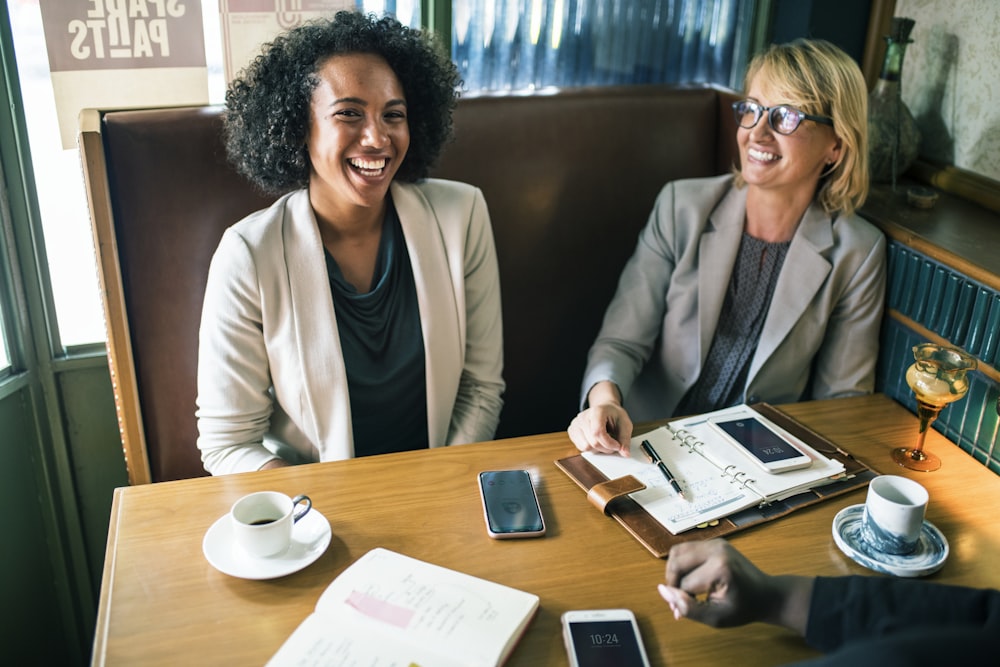 women's sitting on brown cushion chair