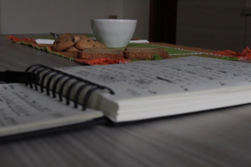 Close-up of handwritten notes on a wooden table.