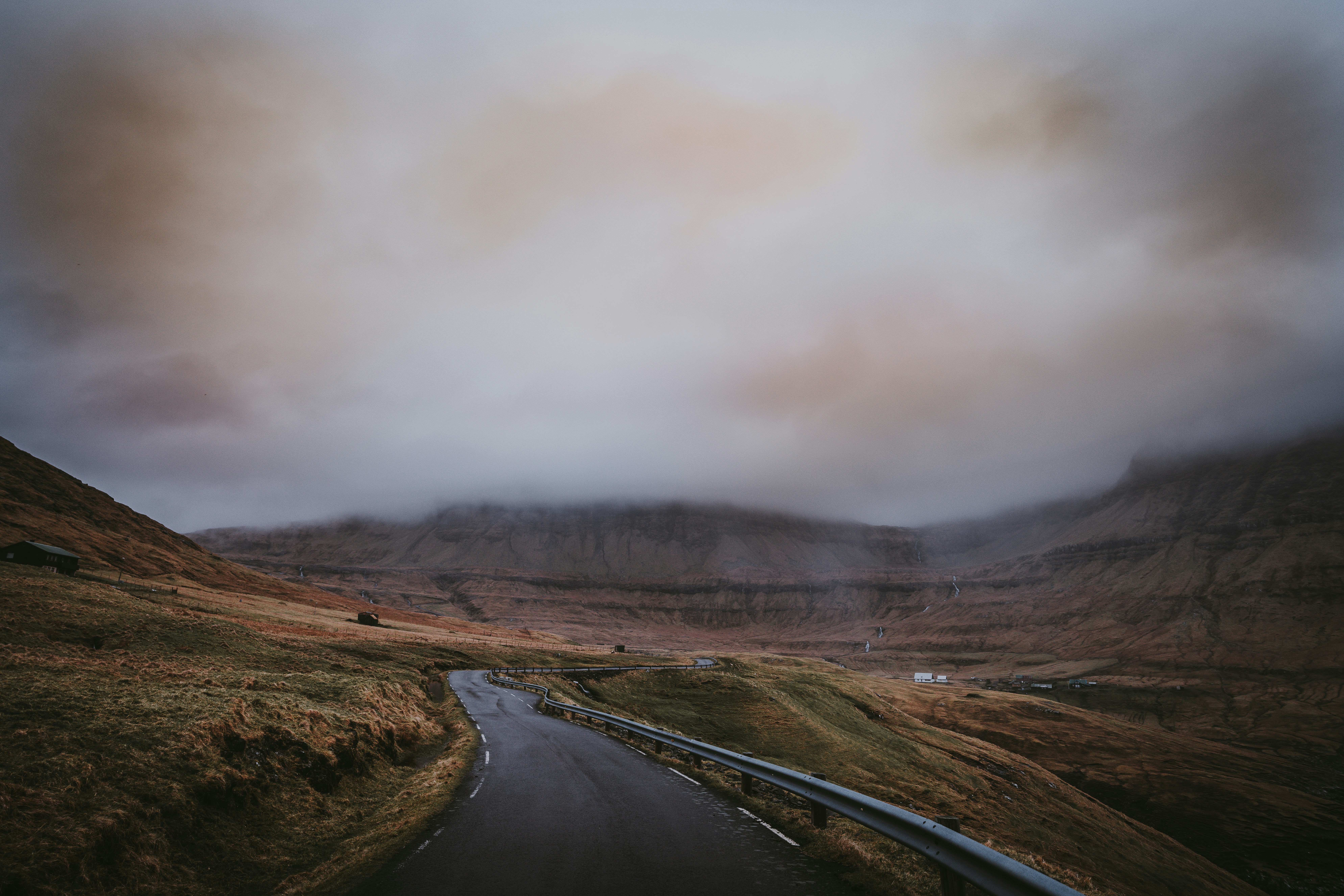 black road between mountains