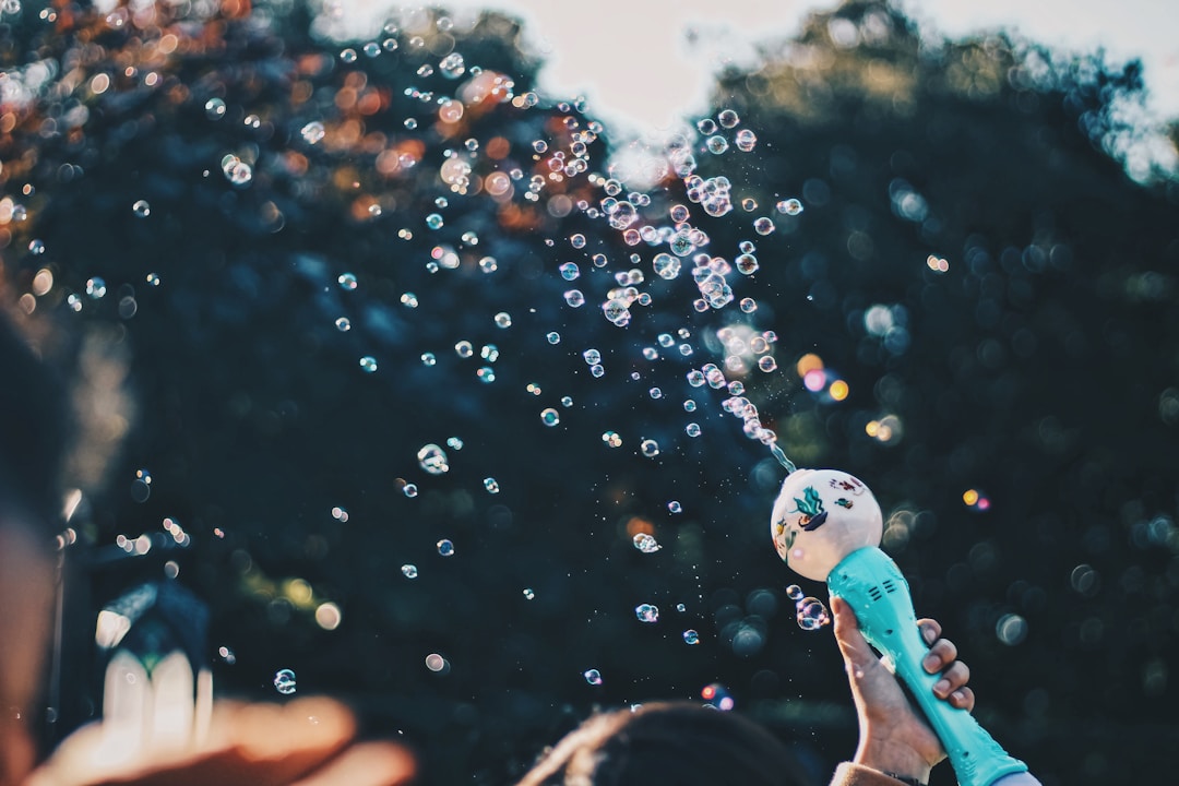 Someone shooting bubbles into the air.