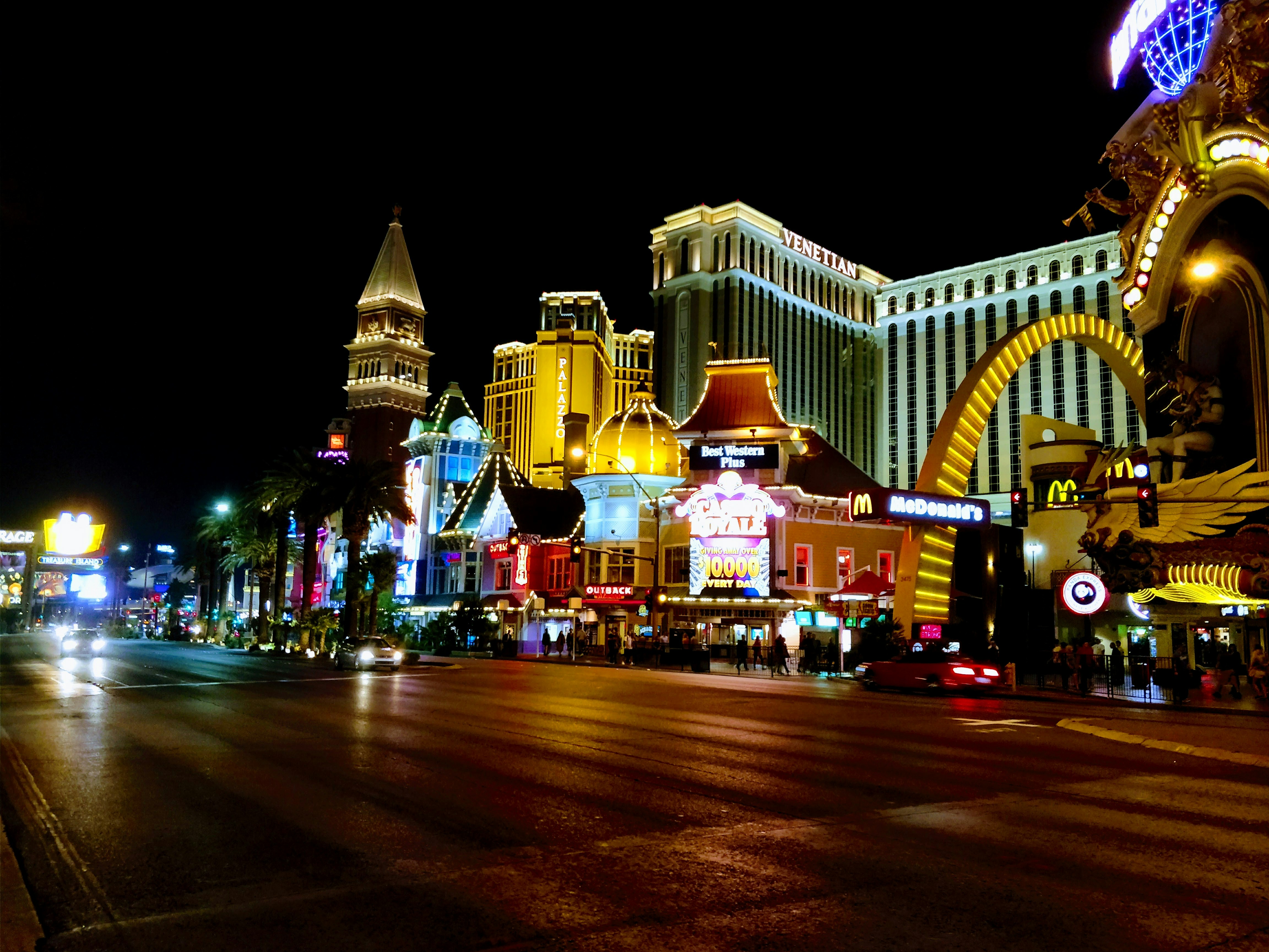 Illuminated Las Vegas strip at night with casino lights and bustling crowds