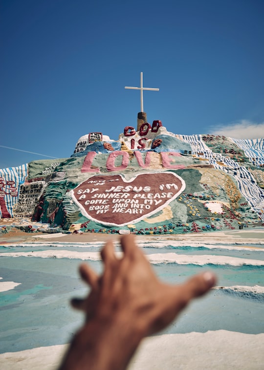photo of bible quote-themed landmark in Salvation Mountain United States