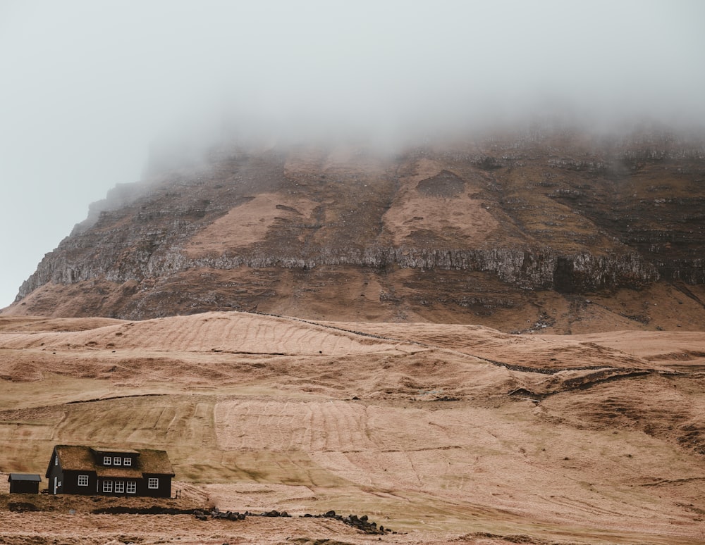 brown house at the foot of rock formation