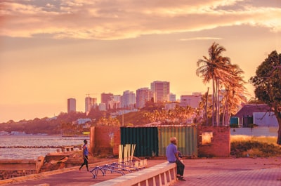 man seating beside body of water mozambique google meet background