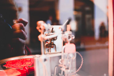Close-up of an automatic shutter mechanism being serviced by a technician.