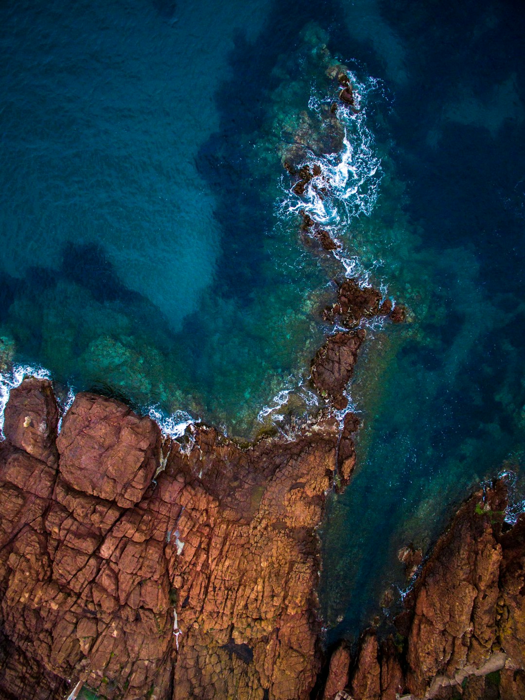 aerial view of calm sea near rock formation