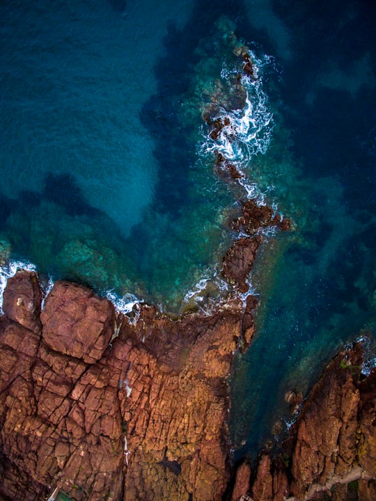 aerial view of calm sea near rock formation in Saint-Raphaël France