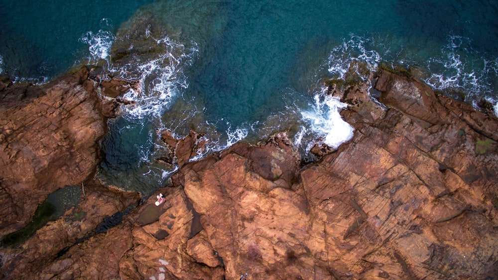bird's eye-view photography of cliff and body of water