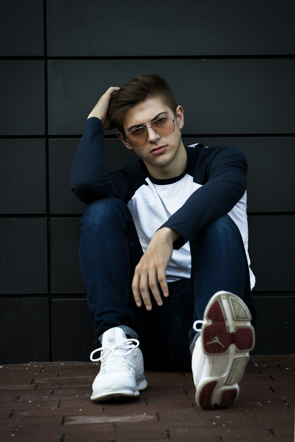 man sitting on brick floor