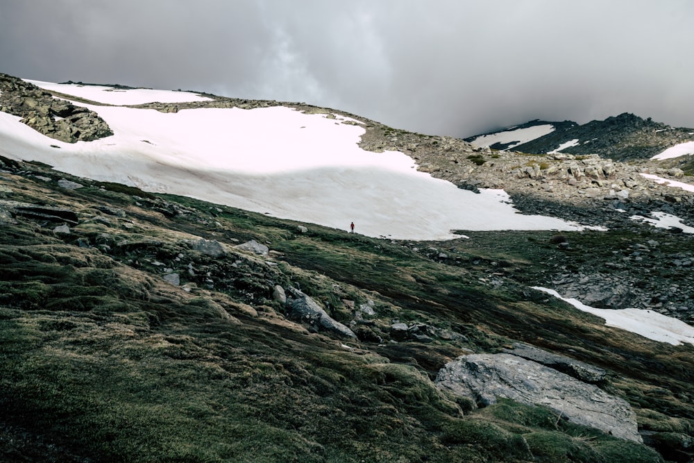 snow covered mountain under grey sky