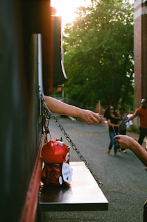 person reaching card beside trailer