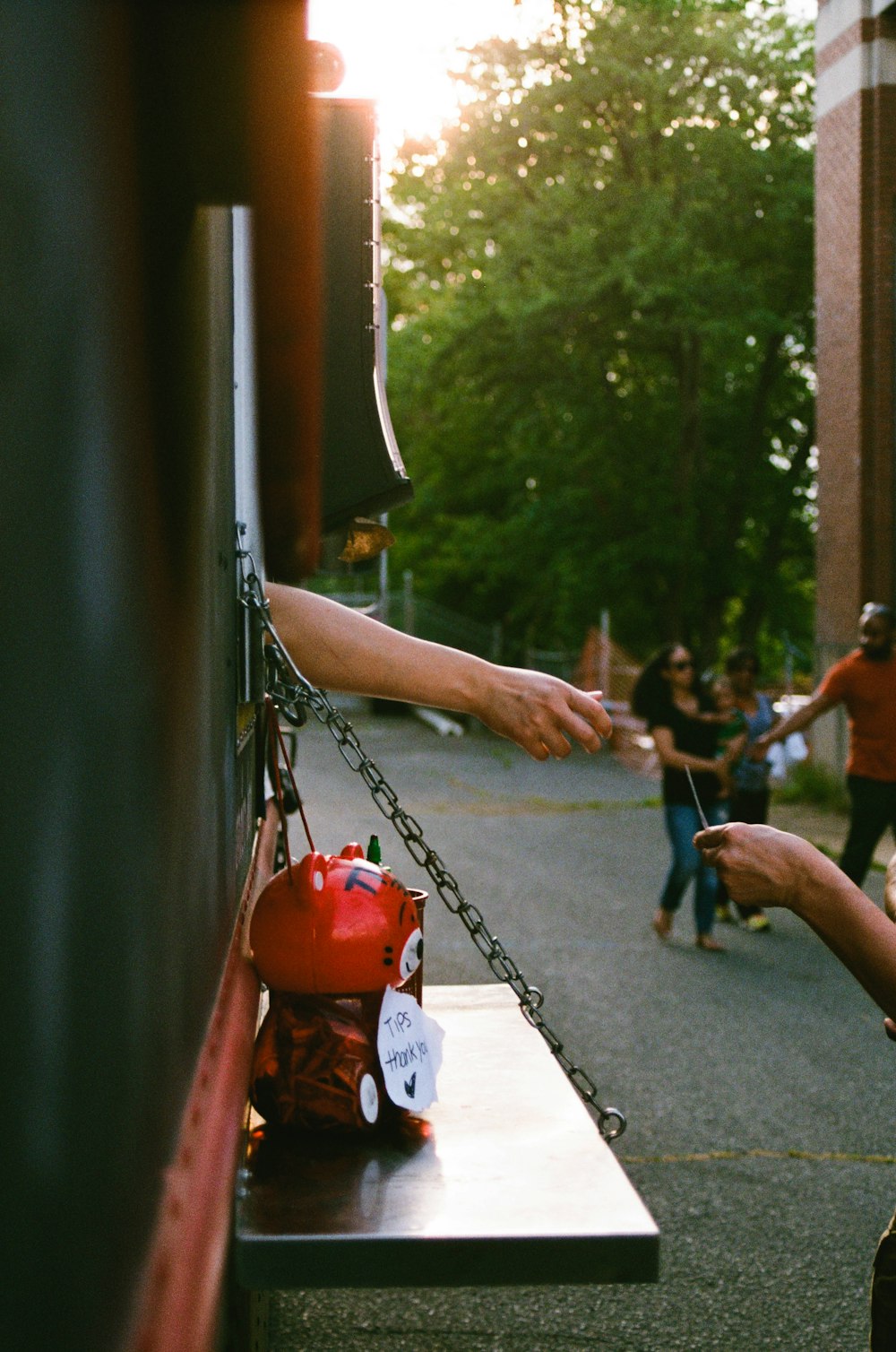 person reaching card beside trailer