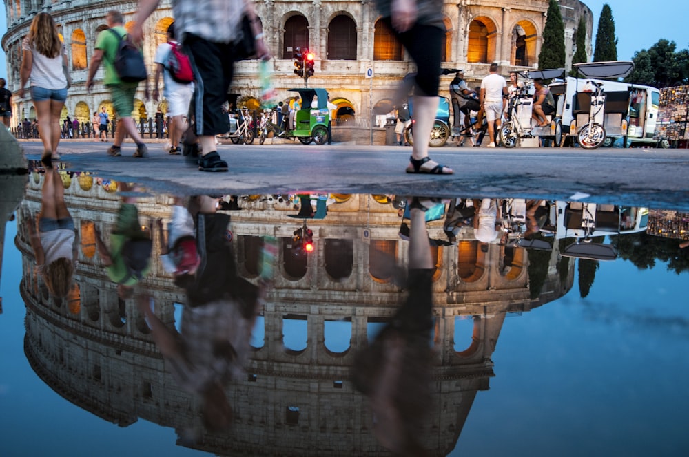 people walking beside The Colosseum, Rome at blue hour