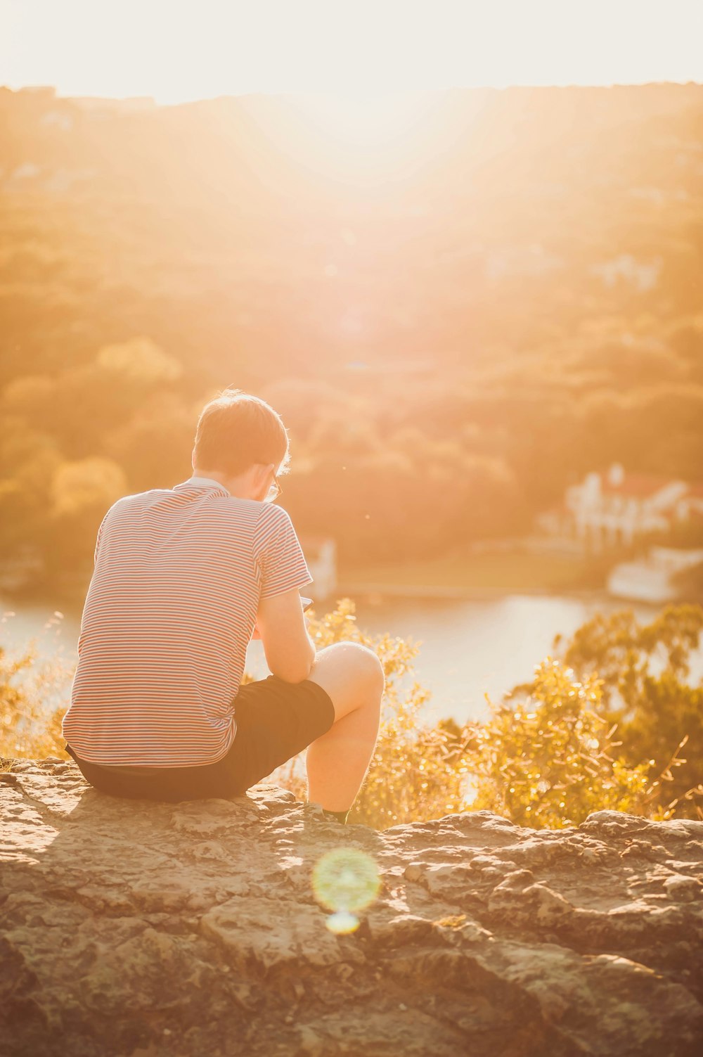 man sitting on rock