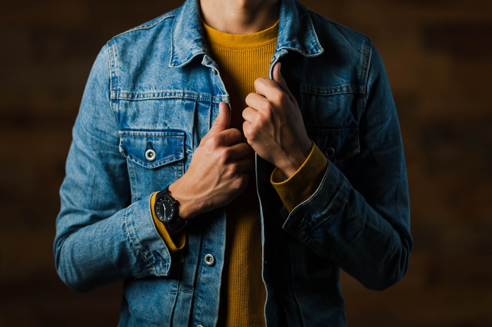 man wearing blue denim jacket